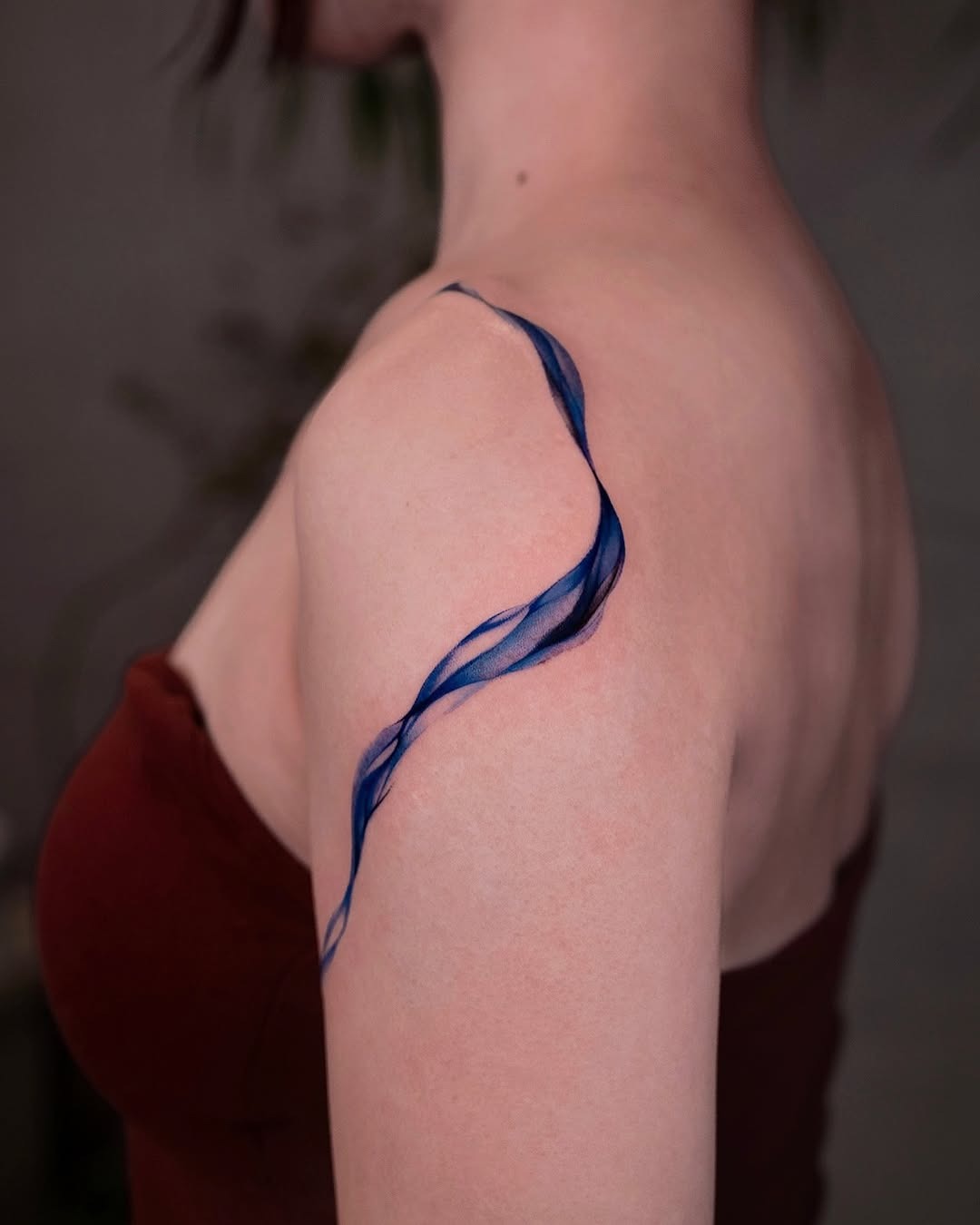 Elegant blue wave tattoo adorning the shoulder Tattoo Design
