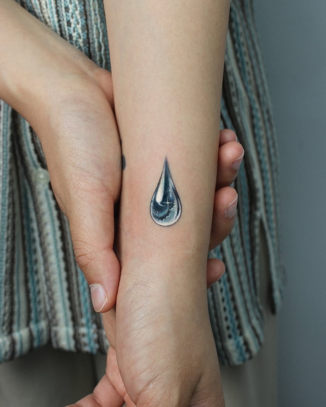 Elegant Water Drop Tattoo on the Arm Tattoo Design
