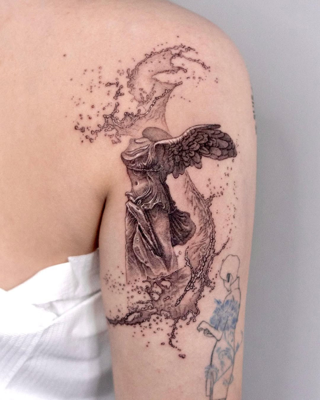 Elegant water-themed winged tattoo design Tattoo Design