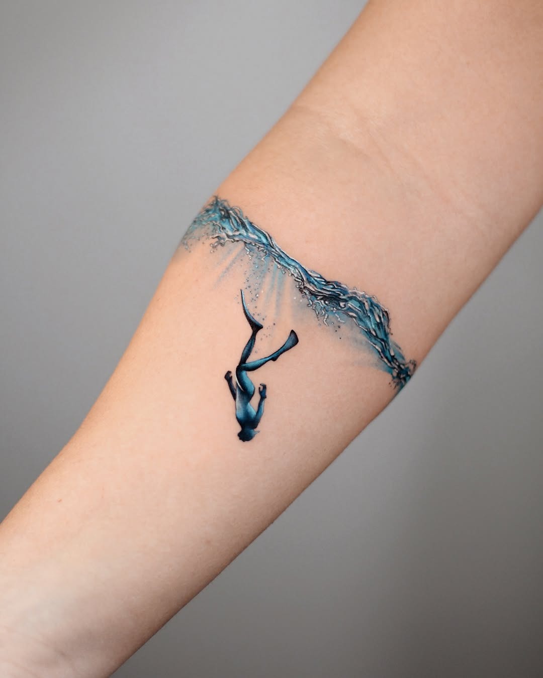 Elegant whale diving through artistic water waves Tattoo Design