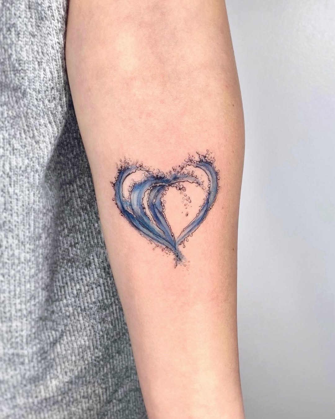 Flowing waves create a heart-shaped tattoo Tattoo Design
