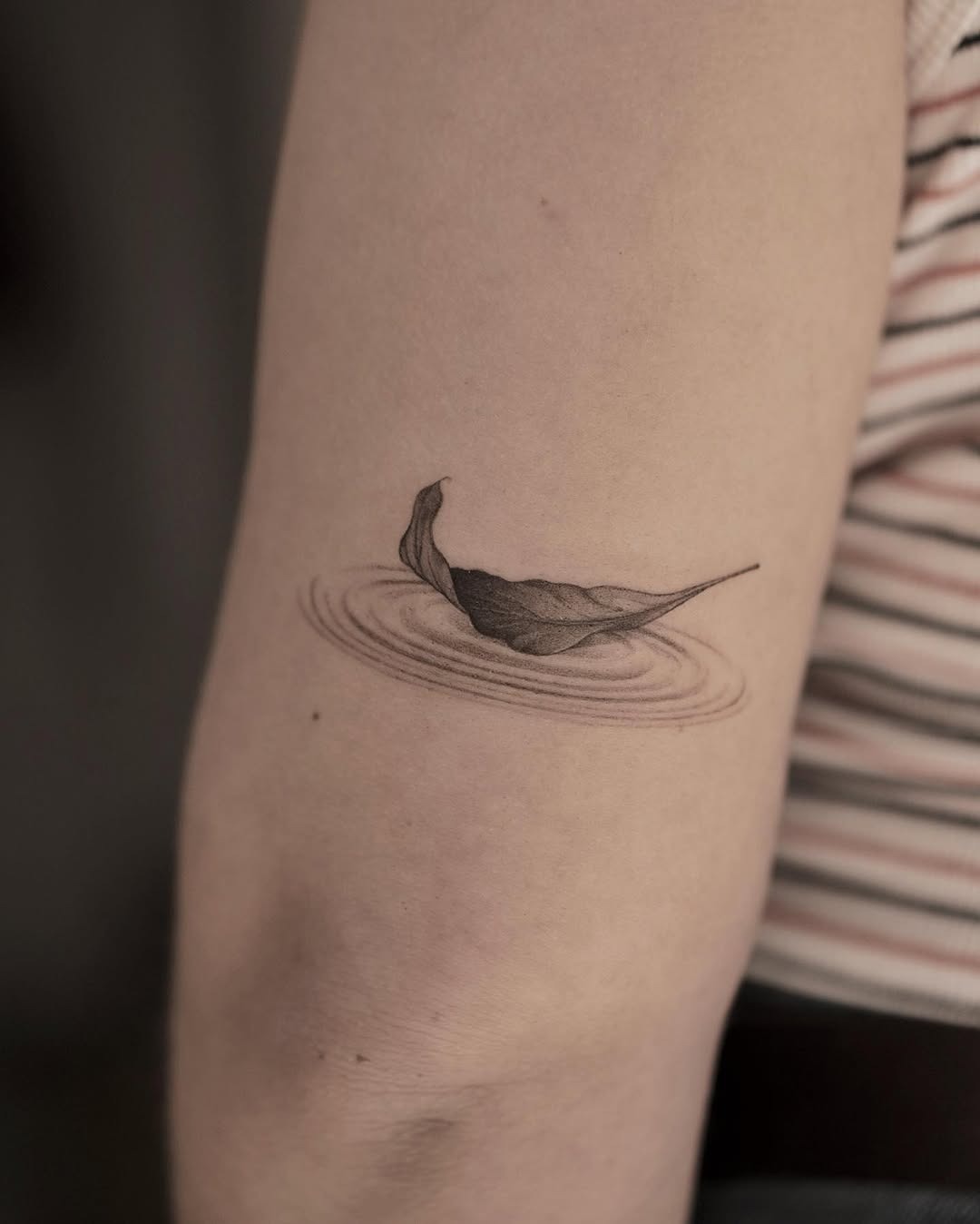 Minimalist tattoo of a leaf on water Tattoo Design