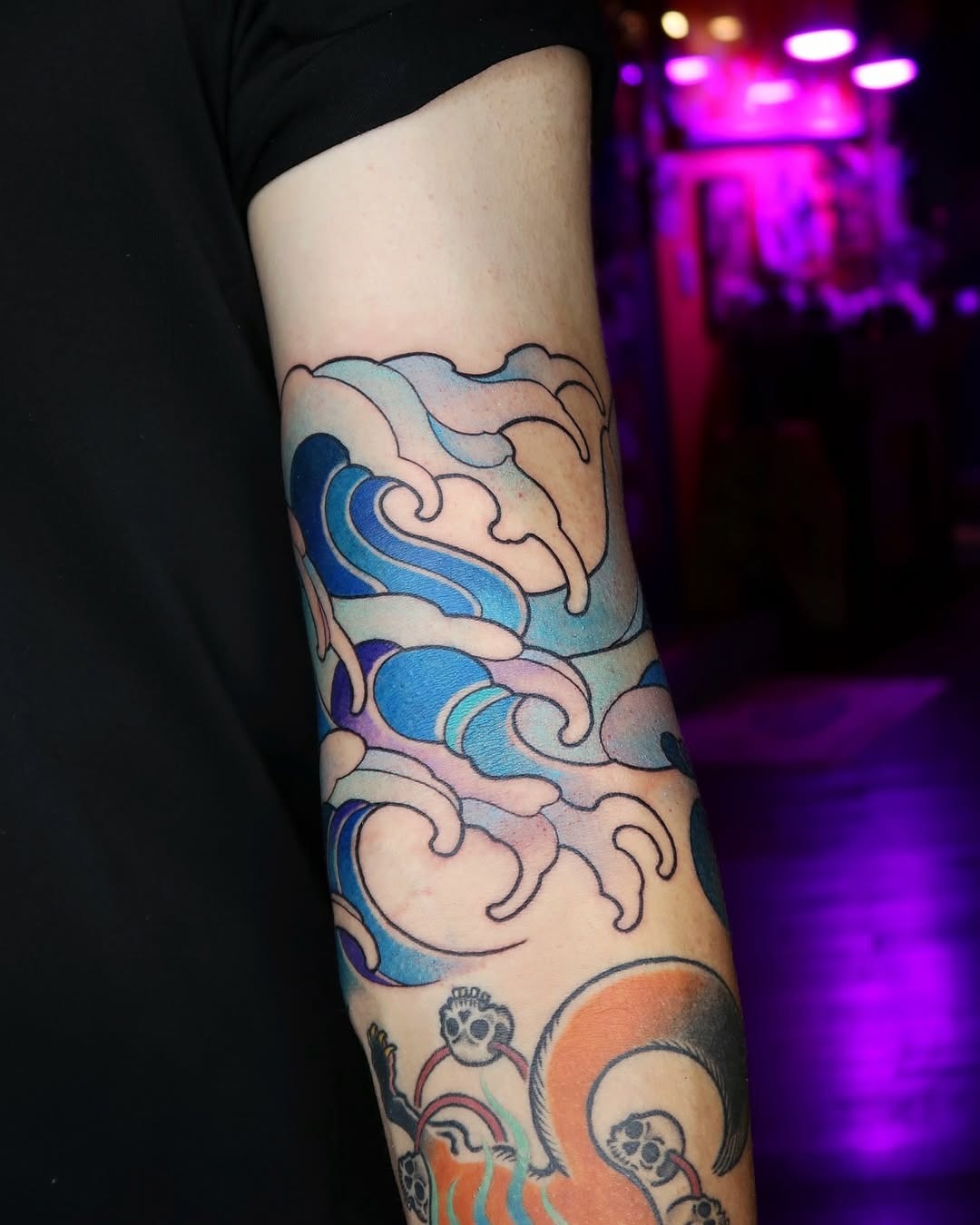 Vibrant Waves Dancing on Skin Tattoo Design
