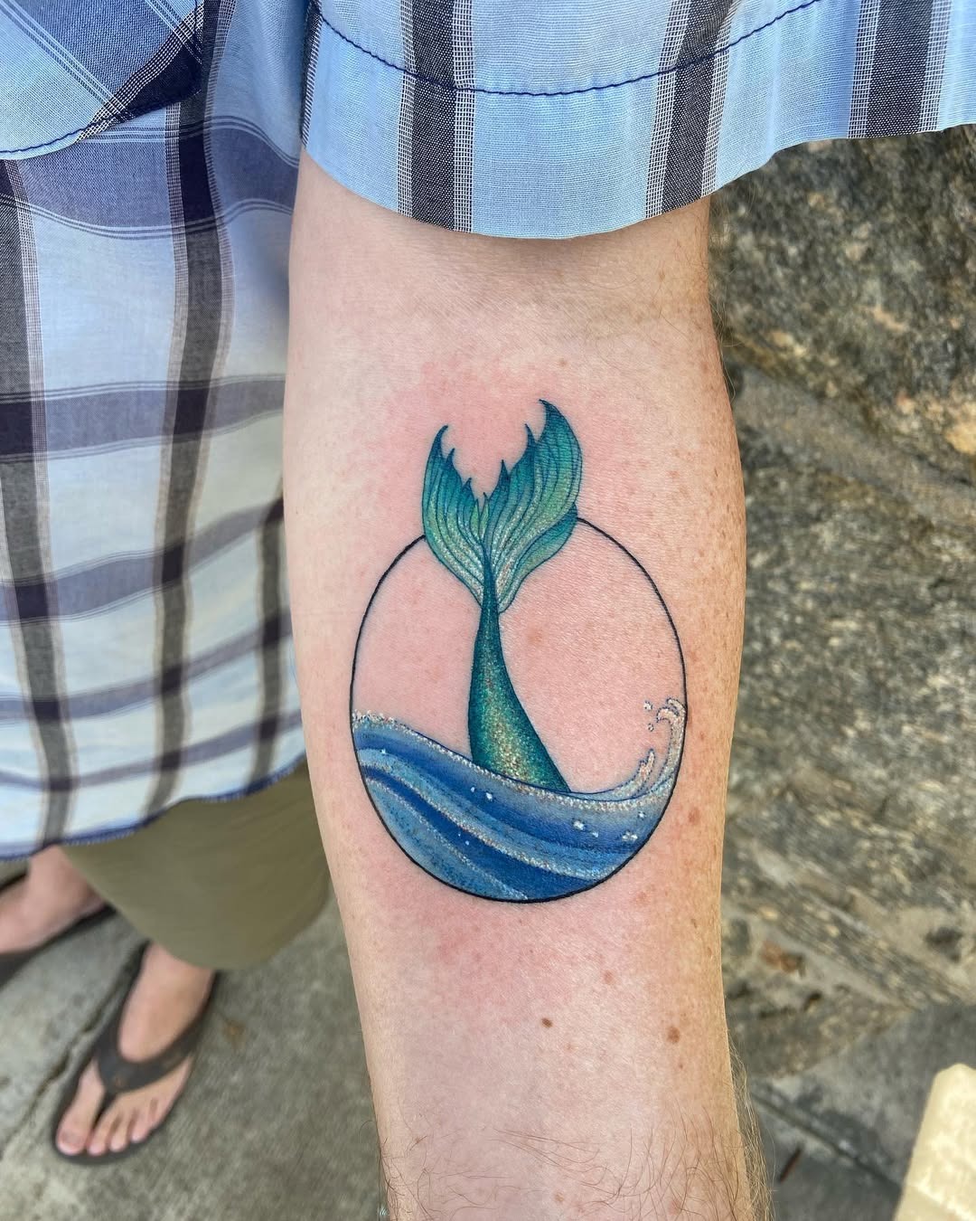 Whimsical whale tail tattoo with water waves Tattoo Design