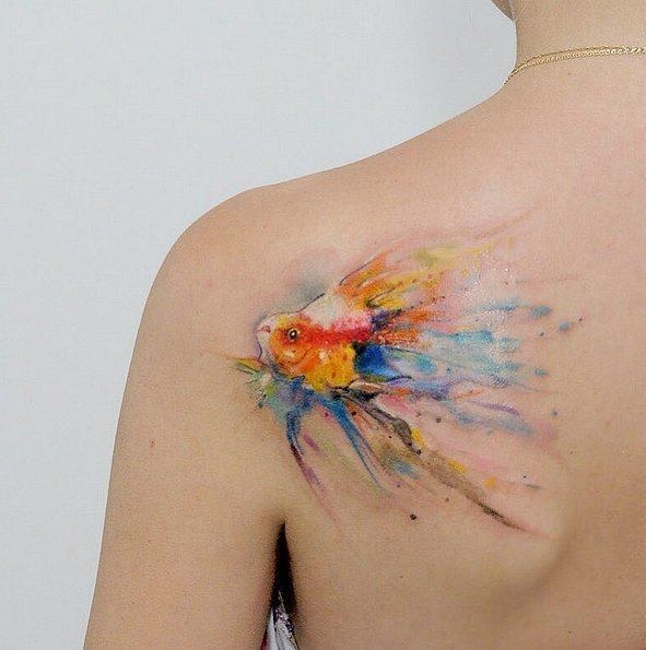 Flowing Fish Swimming Across Upper Back Watercolor Tattoo Tattoo Design