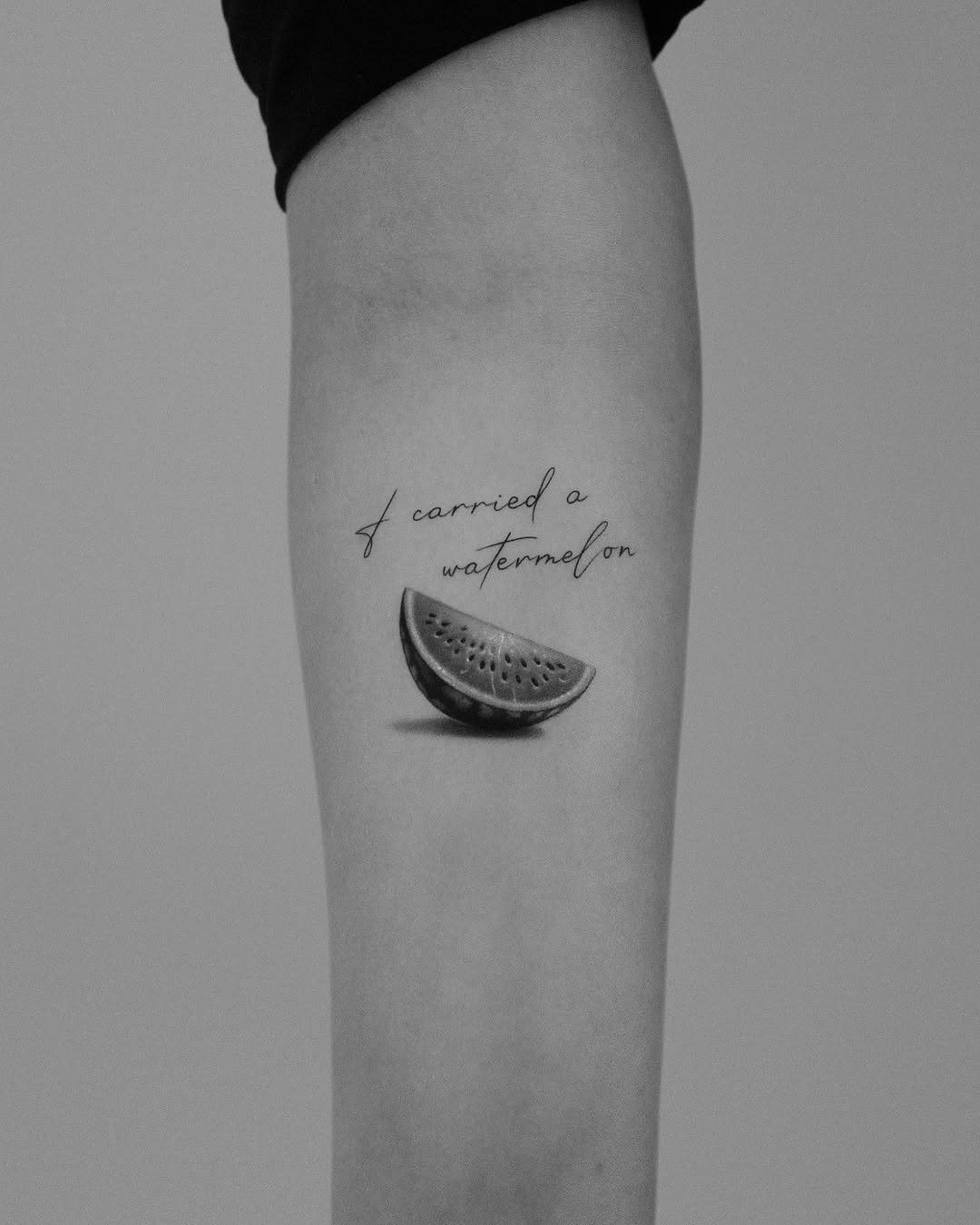 Artistic Watermelon Slice with Elegant Script Tattoo Design