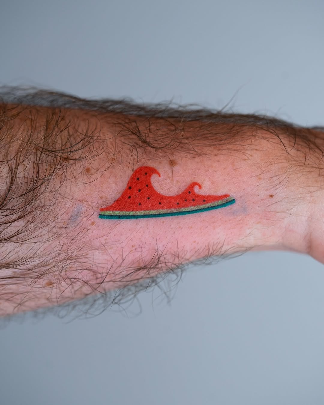 Unique wave-shaped watermelon tattoo design Tattoo Design