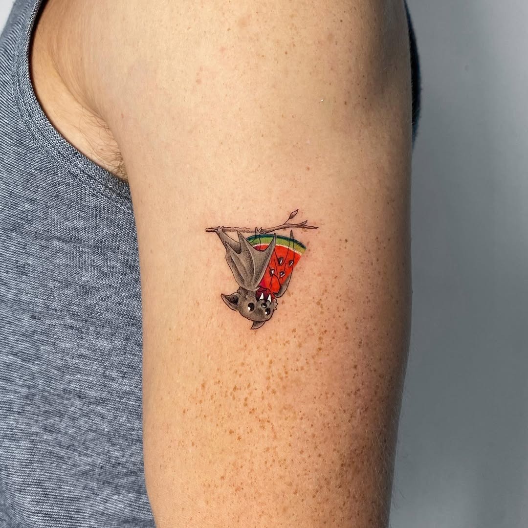 Whimsical bat hanging from a watermelon slice. Tattoo Design