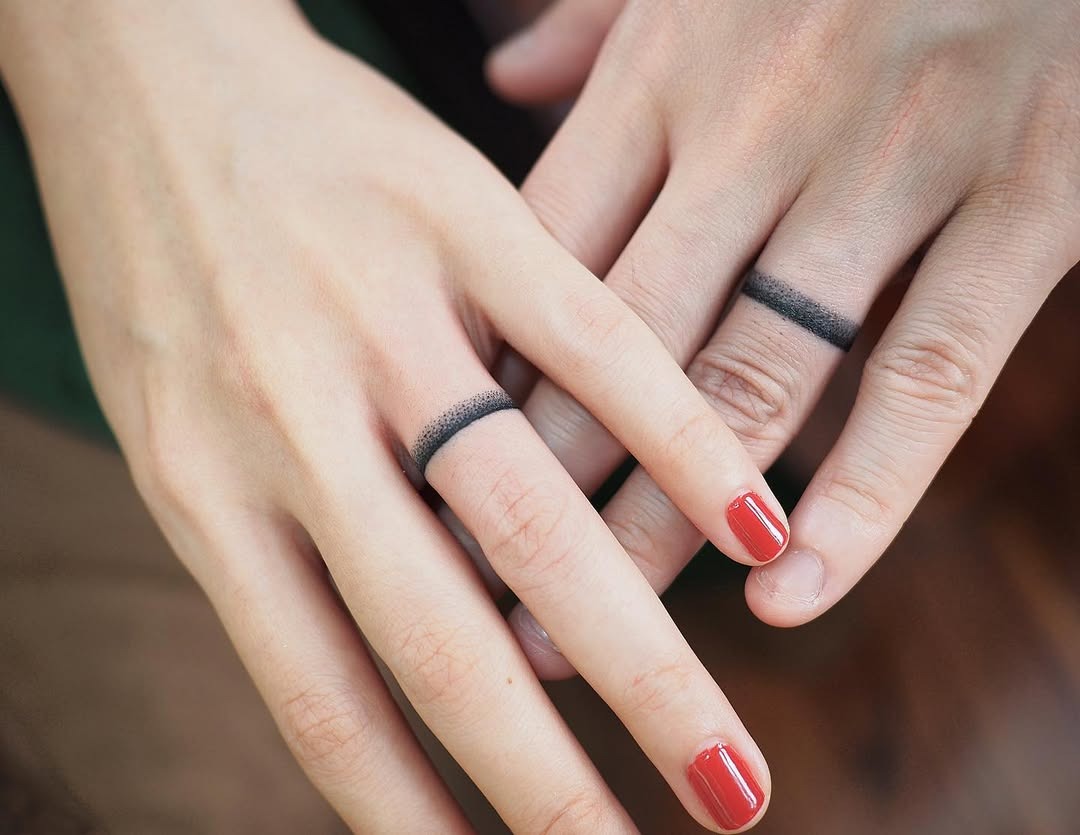 Stylish black band tattooed wedding rings Tattoo Design