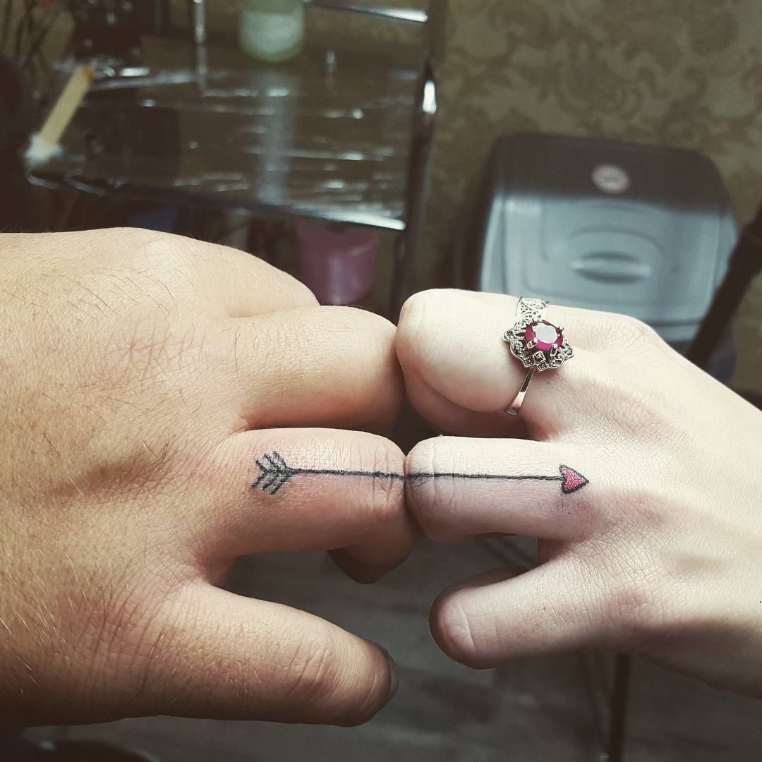 Symbolic arrow tattoos on couple's fingers Tattoo Design