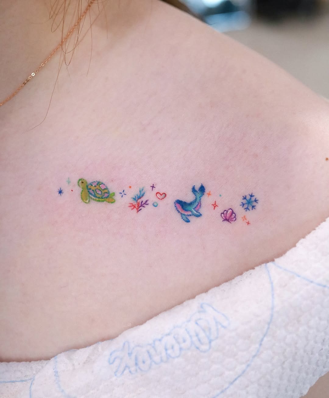 Charming minimalist whale tattoo with vibrant colors Tattoo Design