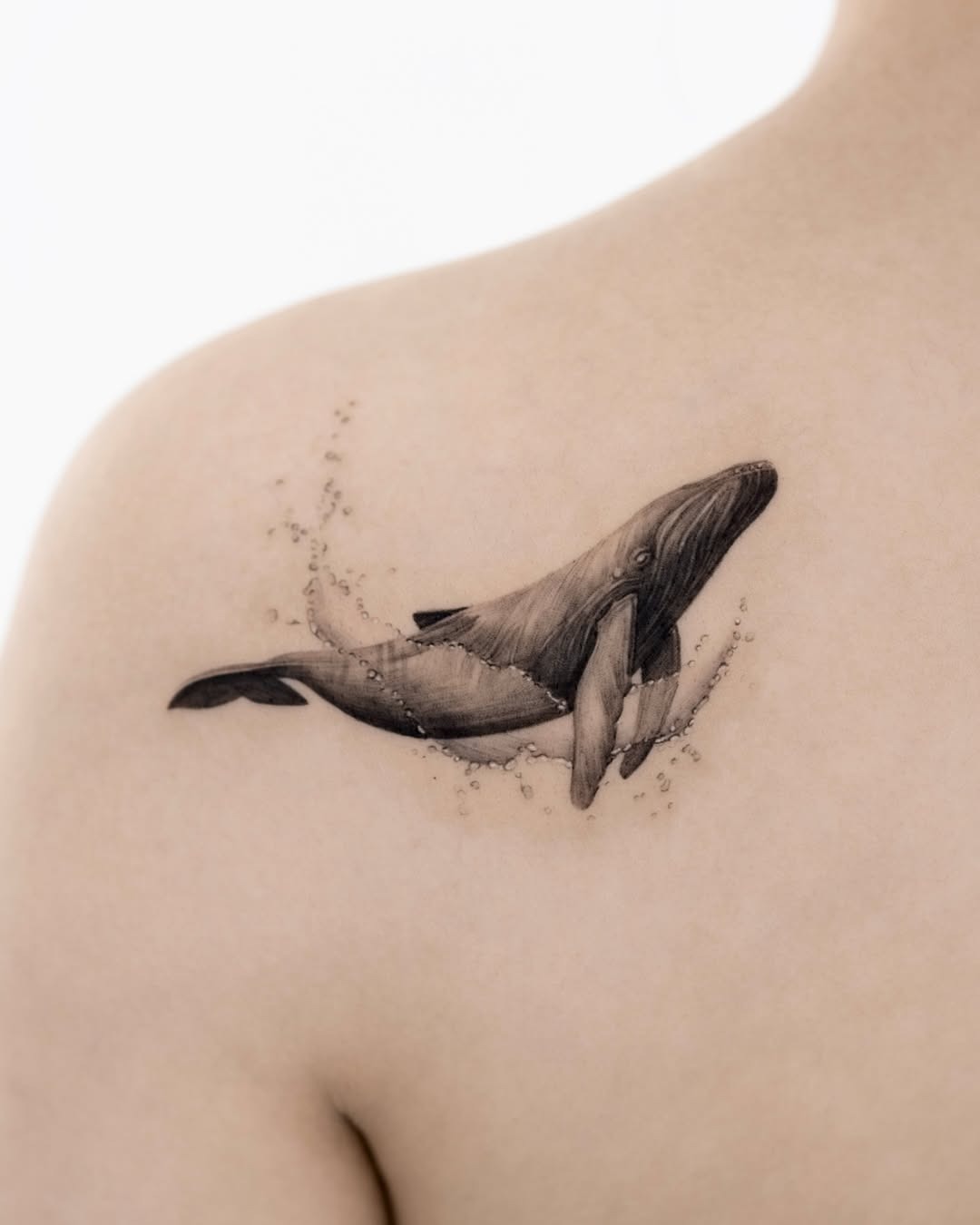 Elegant black and gray whale tattoo on shoulder Tattoo Design
