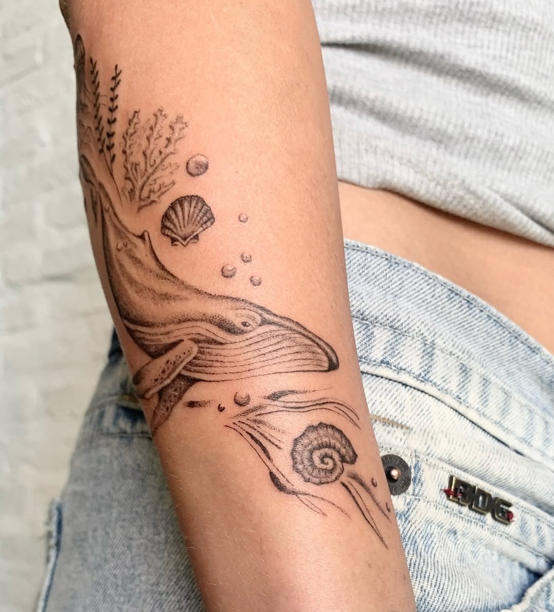 Elegant minimalist whale tattoo on the arm Tattoo Design
