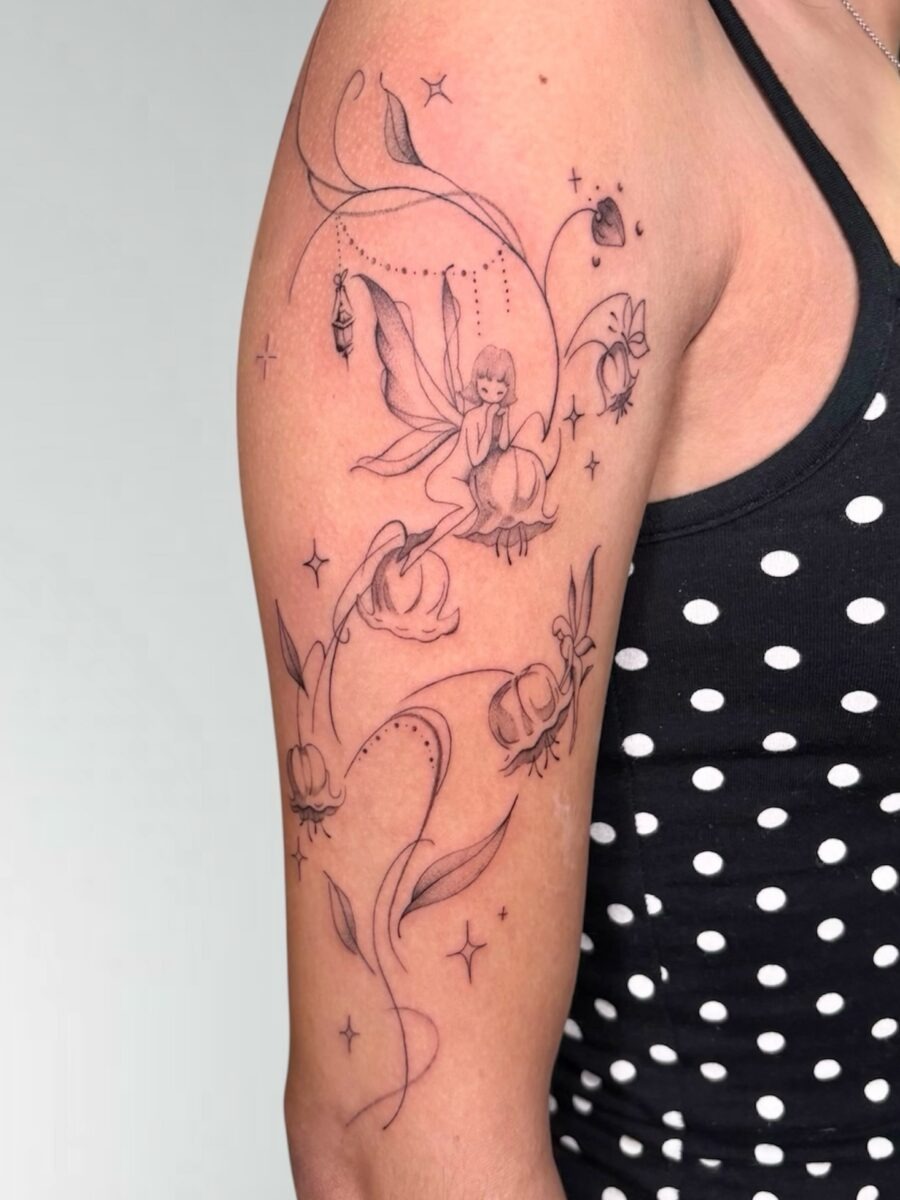Charming fairy amid blooming flowers tattoo Tattoo Design