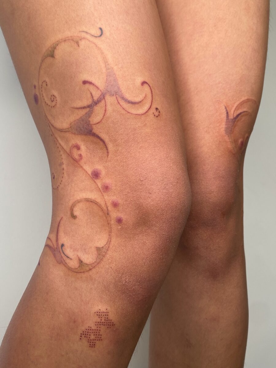 Elegant floral knee tattoo design with subtle hues Tattoo Design
