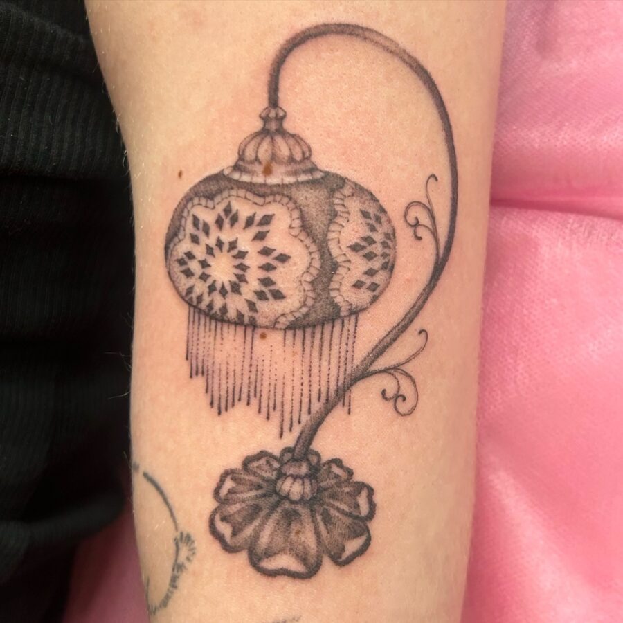 Elegant lantern tattoo with floral accents Tattoo Design