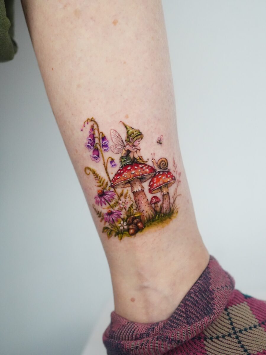 Enchanting fairy atop vibrant mushrooms and flowers Tattoo Design