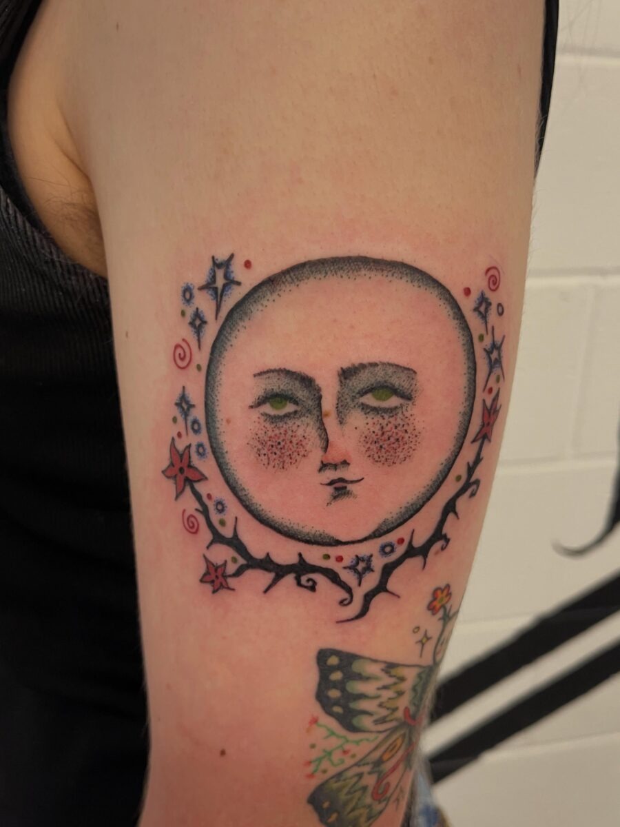 Enchanting moon face tattoo with whimsical details Tattoo Design