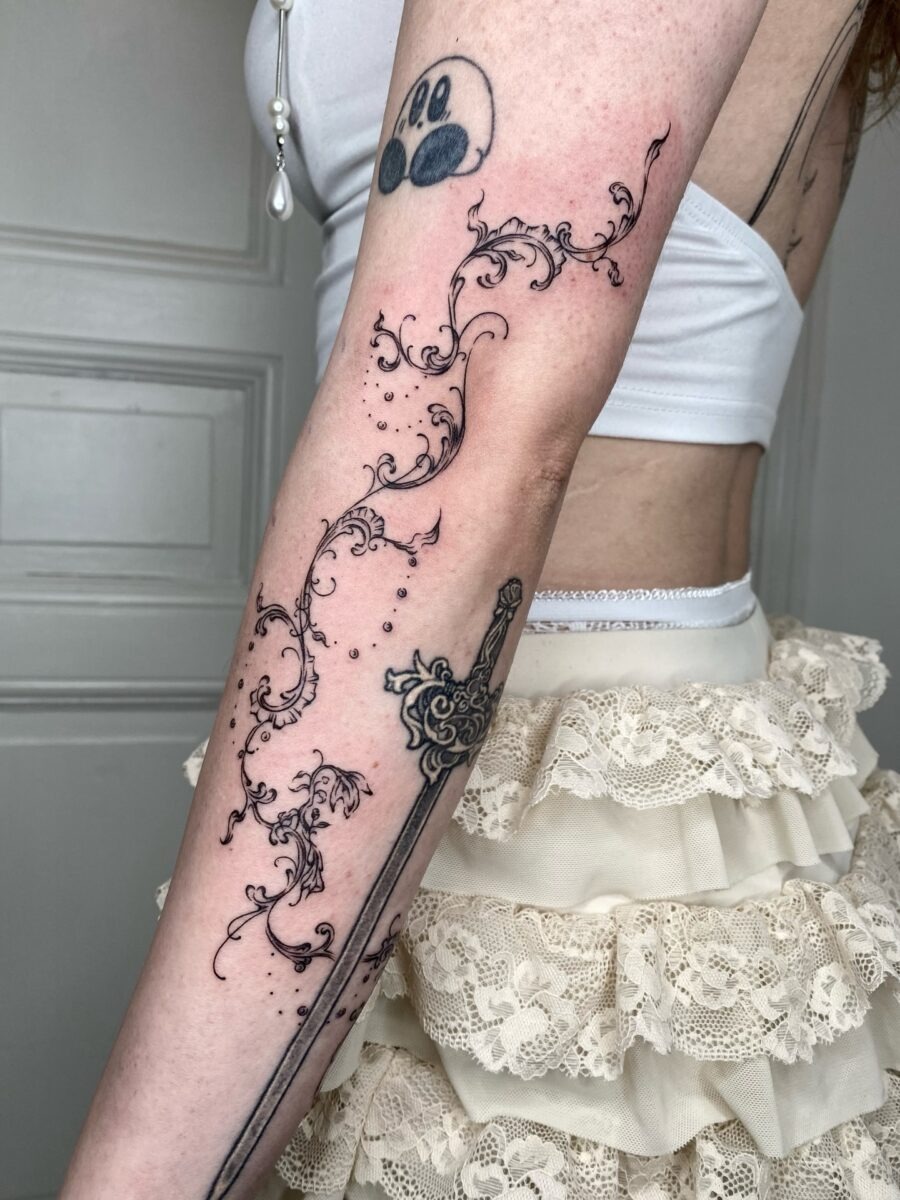 Intricate floral designs paired with a sword Tattoo Design
