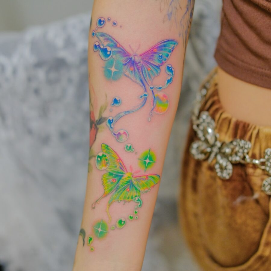Vibrant butterflies dancing in sparkling hues Tattoo Design