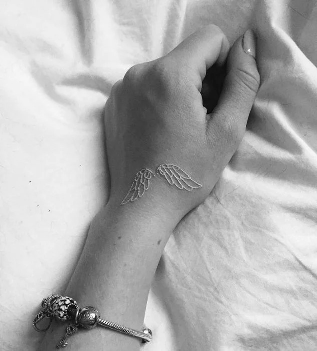 Liberation in a Pair of Wings White Ink Tattoo Tattoo Design