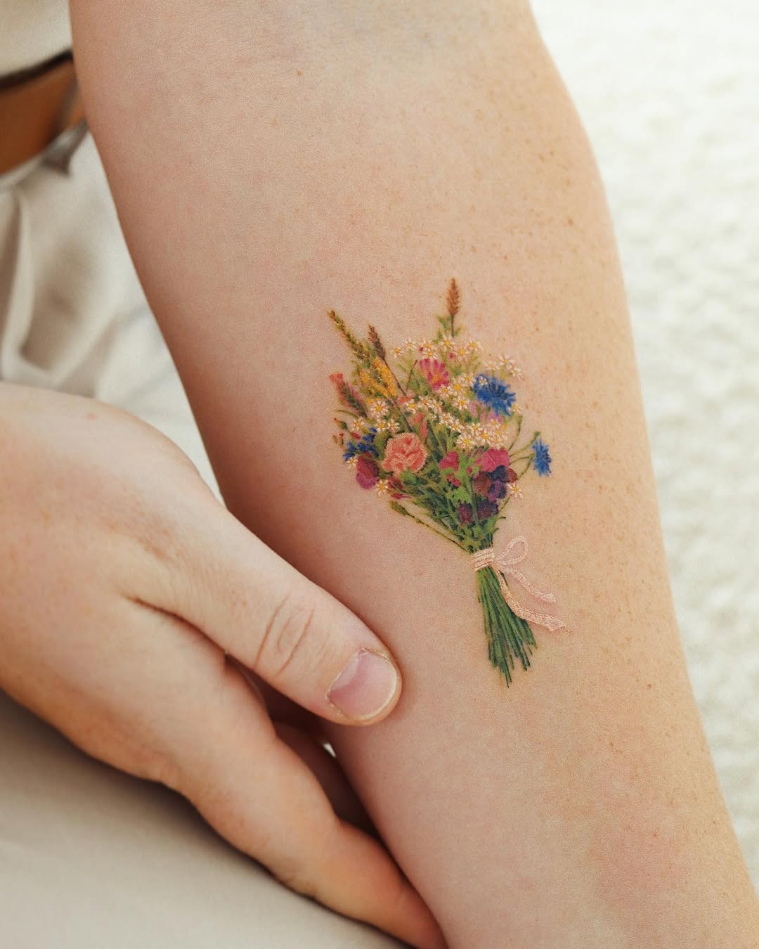 Charming bouquet tattoo adorning an arm Tattoo Design