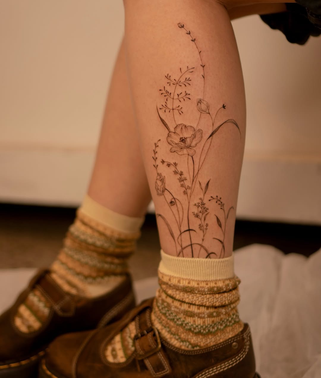 Charming wildflower tattoo on a leg Tattoo Design