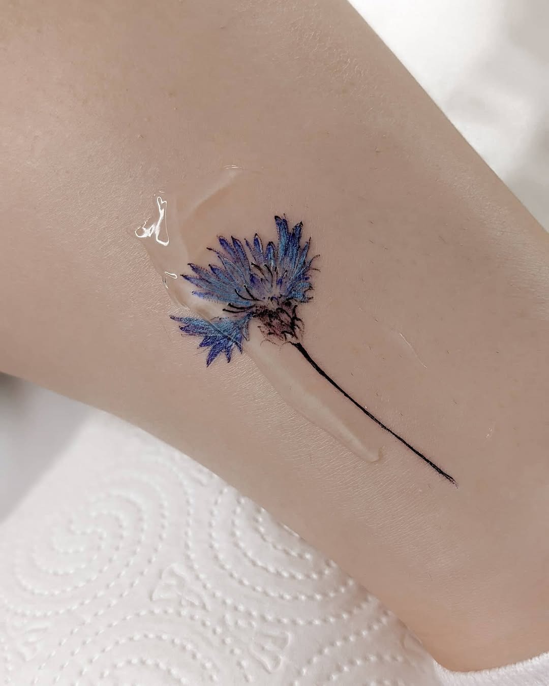 Delicate cornflower tattoo on smooth skin Tattoo Design