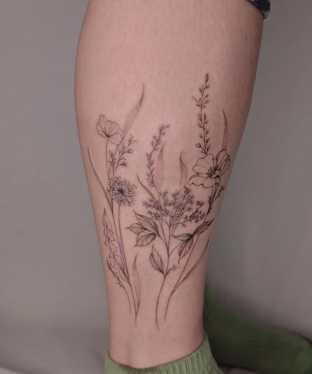 Elegant wildflower tattoo highlighting natural beauty. Tattoo Design
