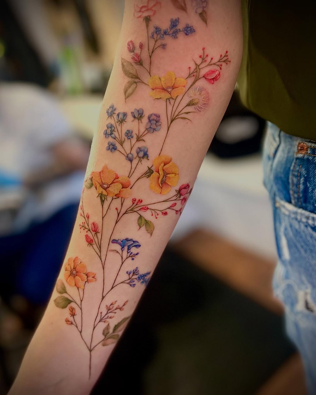 Stunning wildflower tattoo in vibrant colors Tattoo Design
