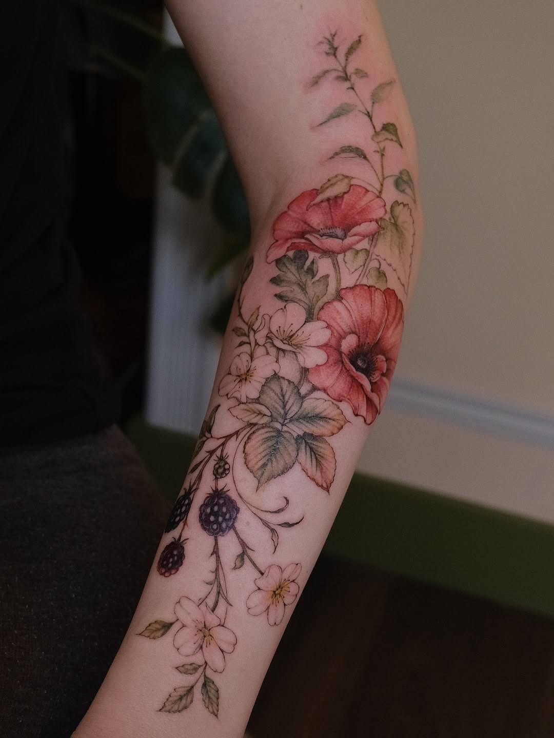 Vibrant floral tattoo design on the elbow Tattoo Design