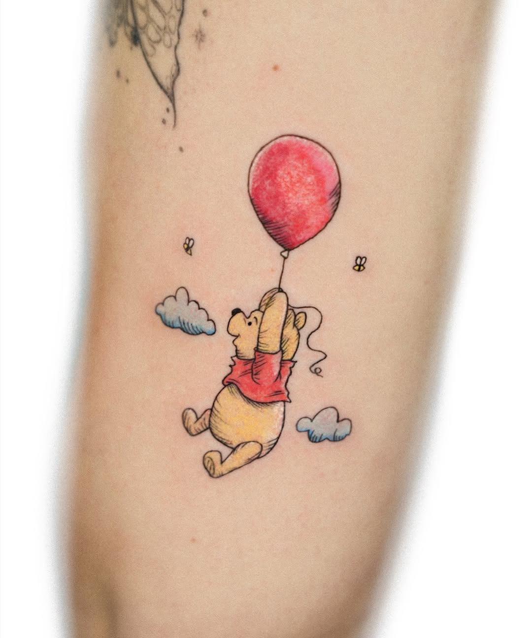 Charming Pooh with a bright red balloon tattoo Tattoo Design