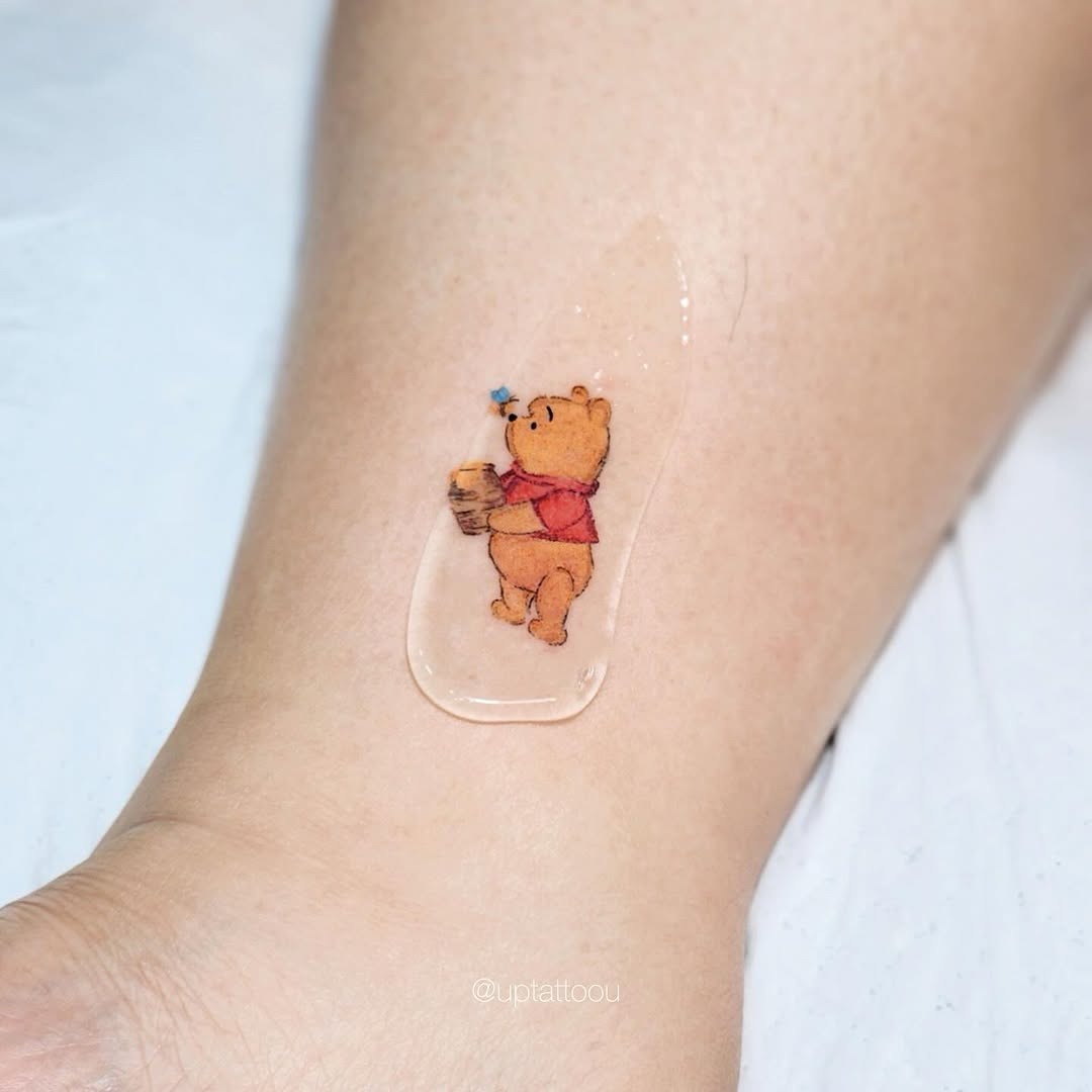 Charming Winnie the Pooh holding honey pot Tattoo Design