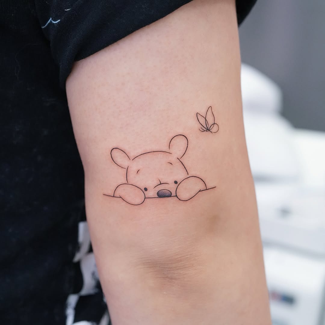 Charming Winnie the Pooh with butterfly accent Tattoo Design