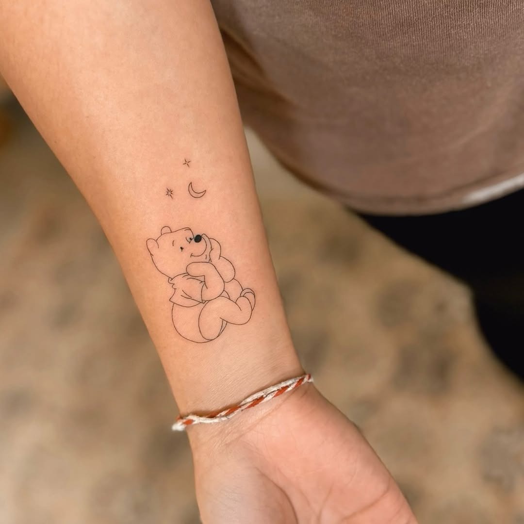 Charming Winnie the Pooh with stars and moon Tattoo Design