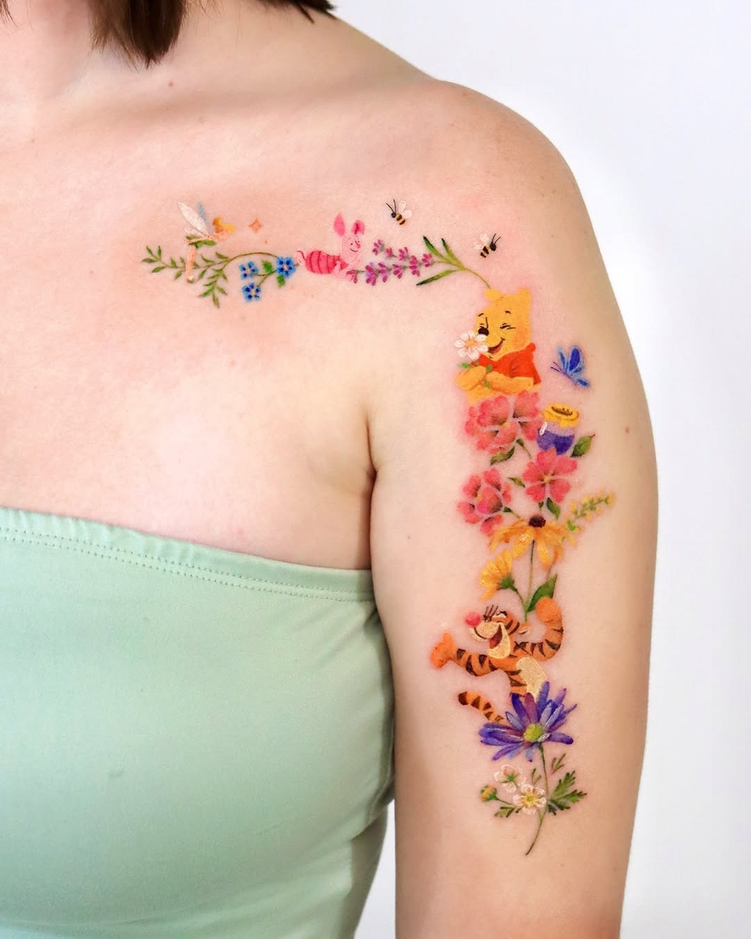 Colorful Winnie the Pooh Floral Arm Tattoo Tattoo Design