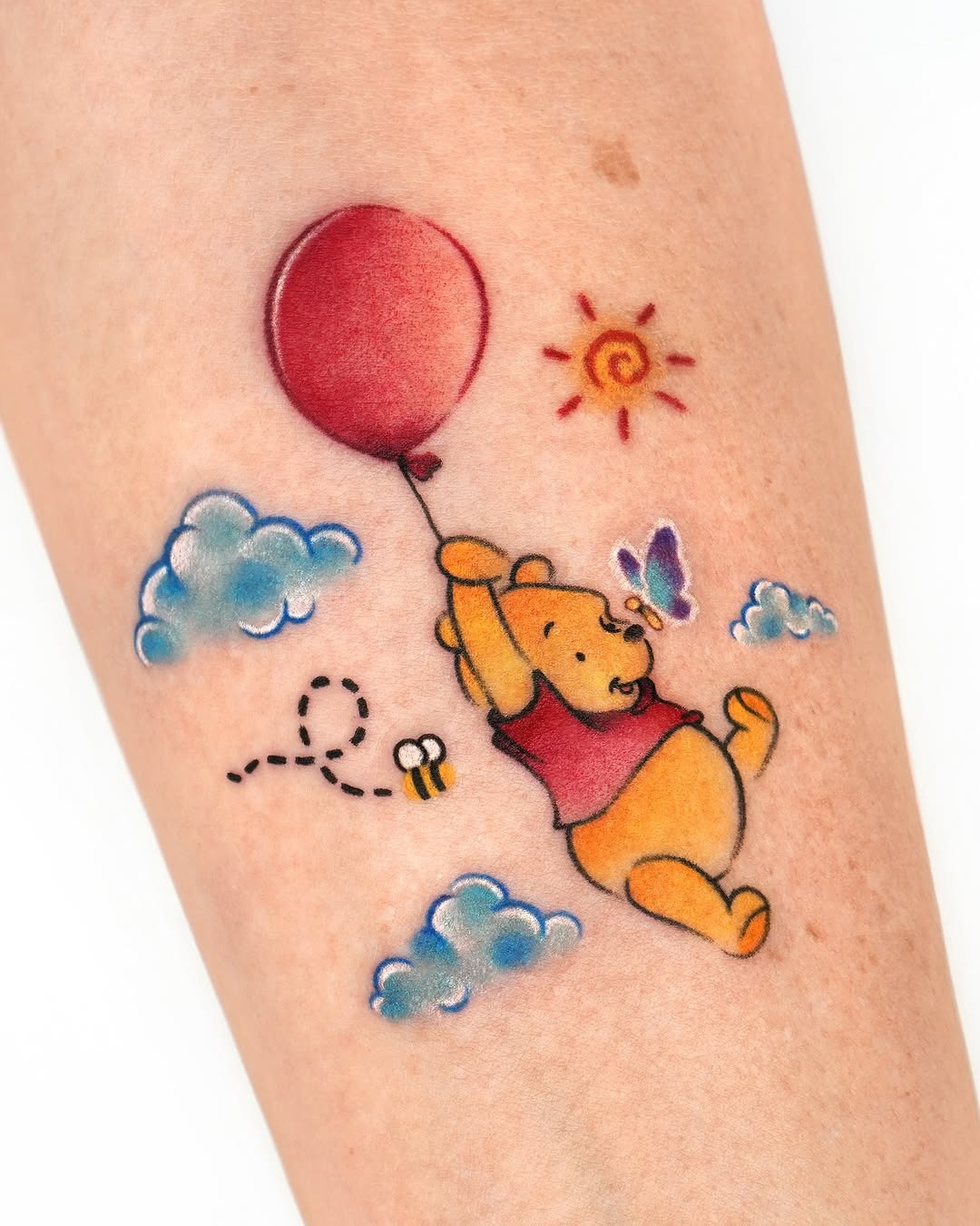 Playful Winnie the Pooh with a Red Balloon Tattoo Design