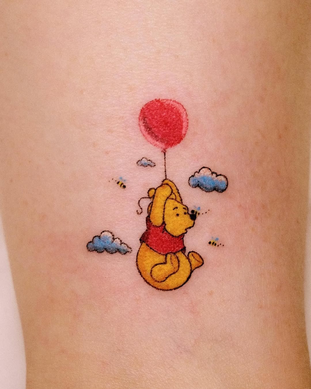 Whimsical Winnie the Pooh with a balloon tattoo Tattoo Design