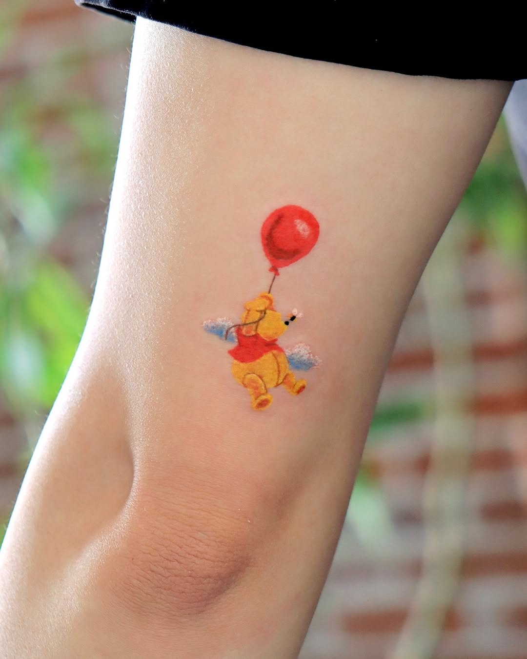 Winnie the Pooh with a red balloon tattoo Tattoo Design