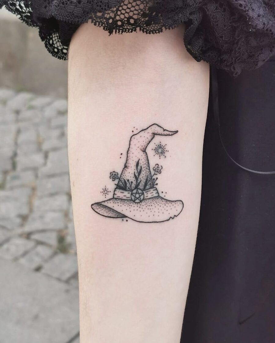 Charming floral witch hat tattoo with a whimsical touch Tattoo Design