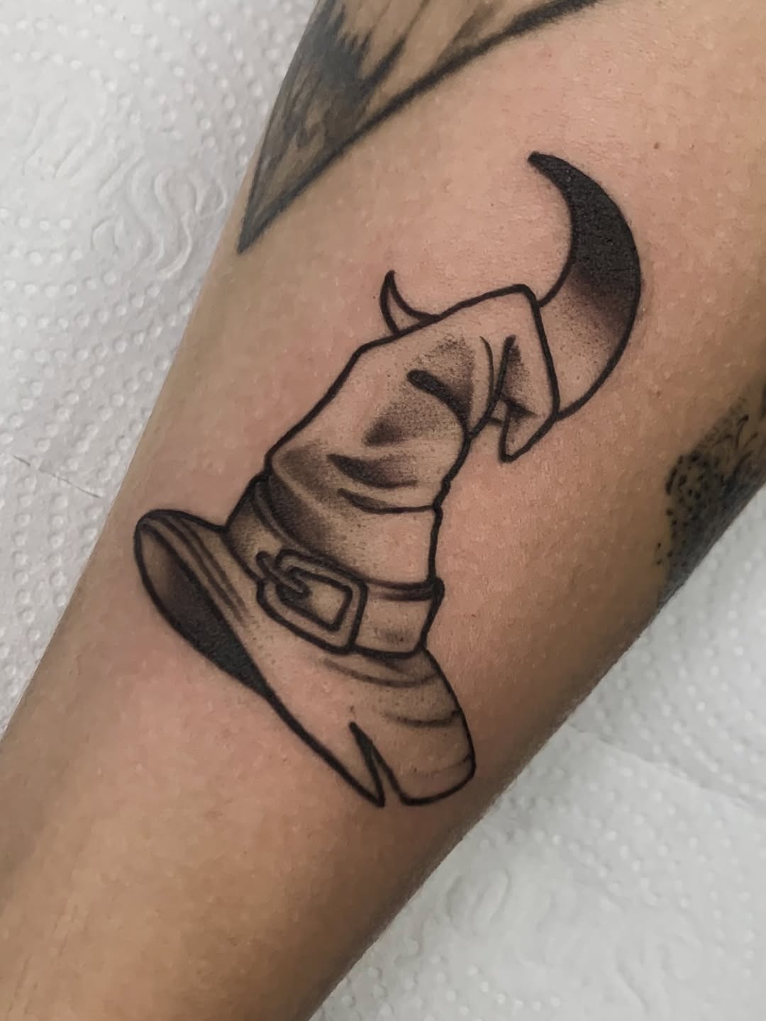 Chic black witch hat tattoo with subtle shading Tattoo Design