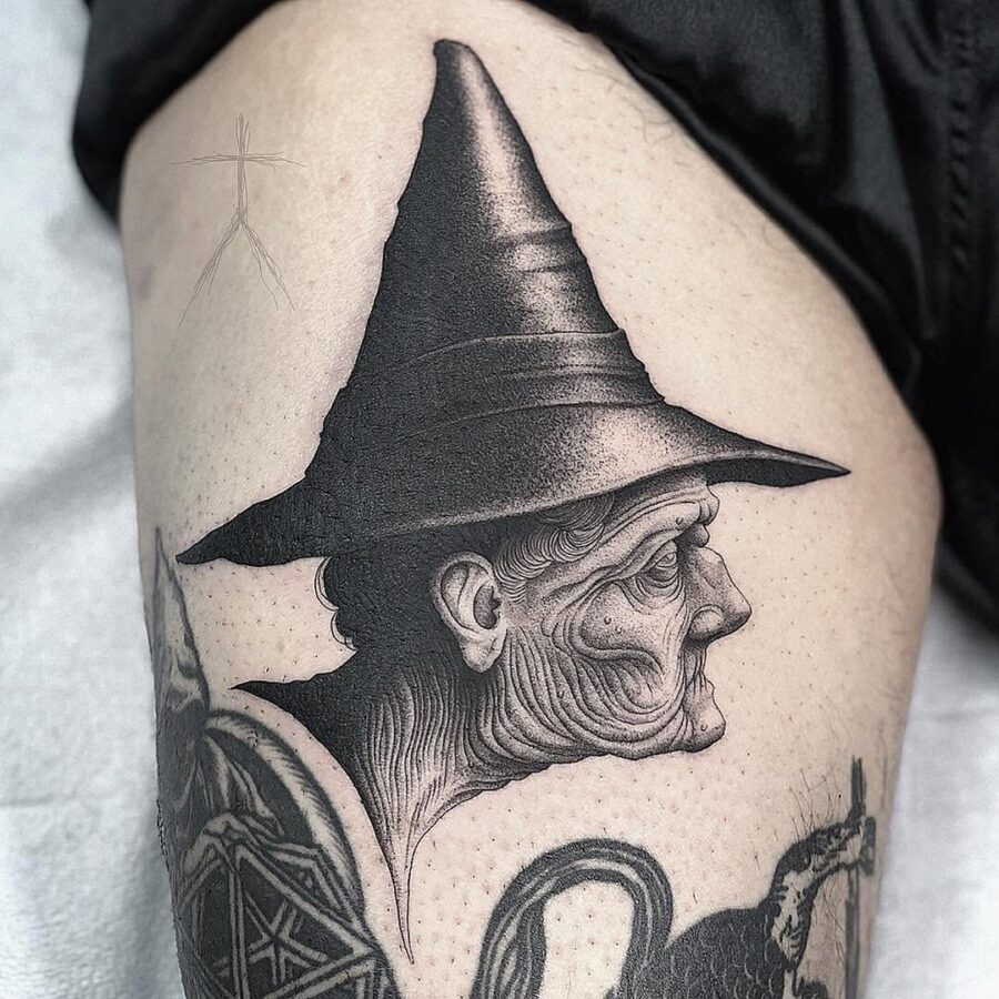 Intricate witch hat tattoo with elderly figure Tattoo Design