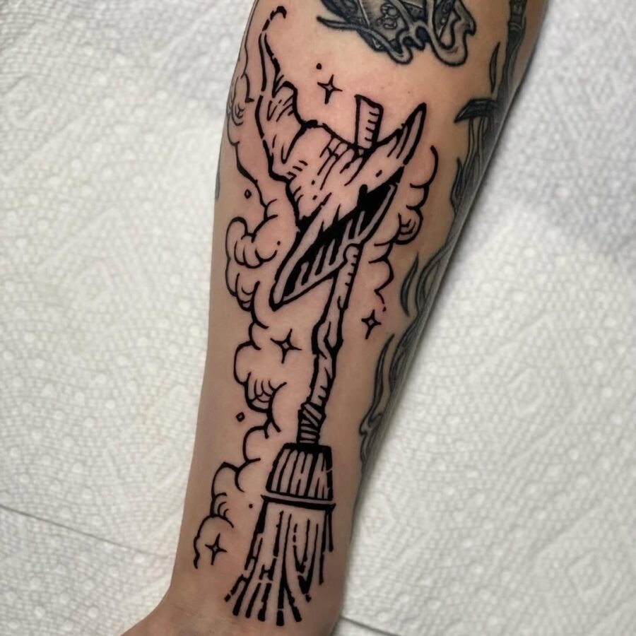 Magical witch hat with broomstick design Tattoo Design