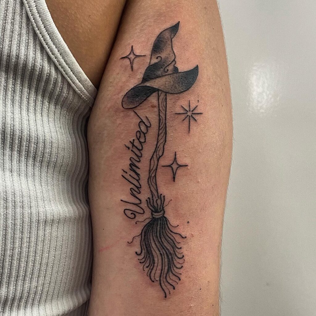 Witch Hat and Broom with “Unlimited” Tattoo Tattoo Design