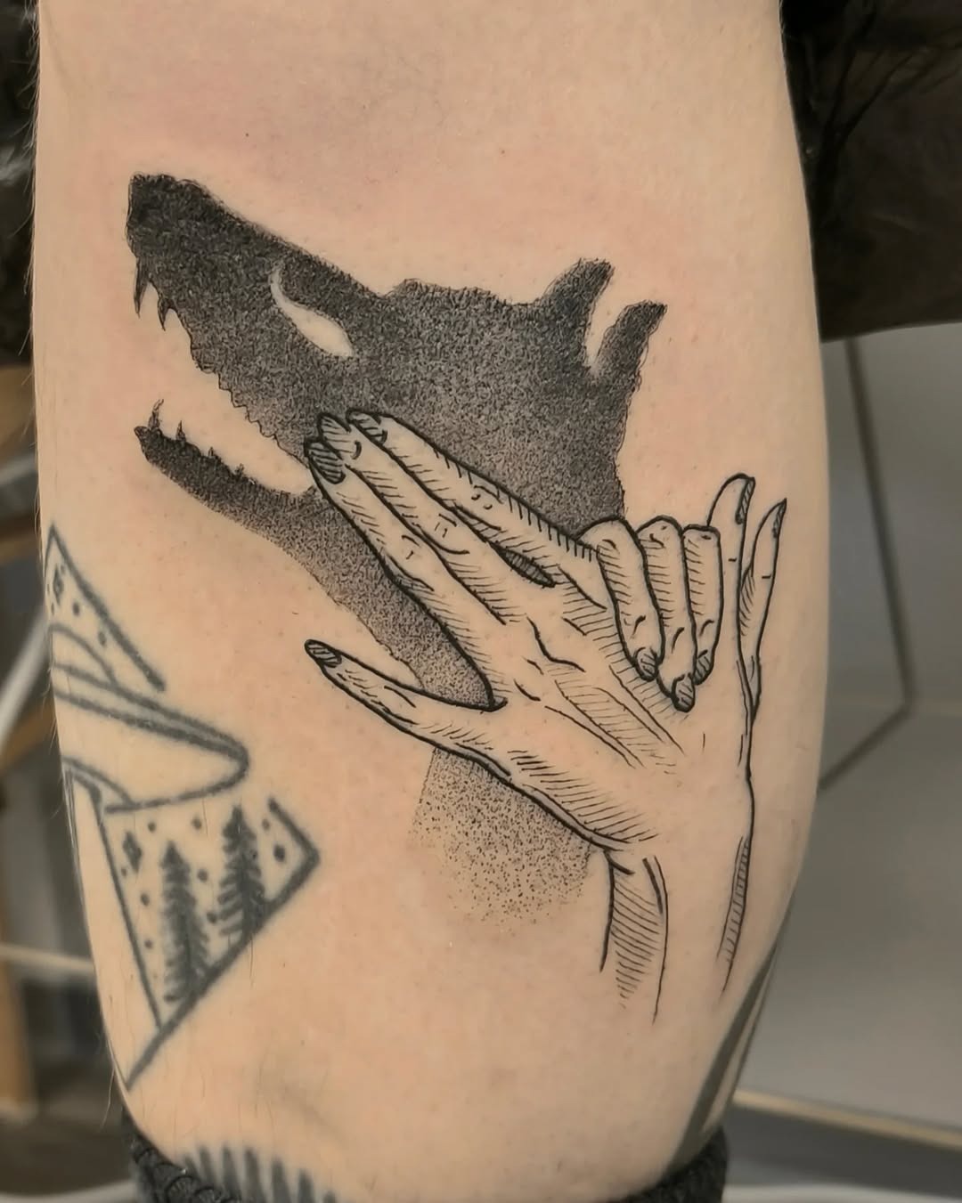 Intricate design blending hands and wolf silhouette Tattoo Design