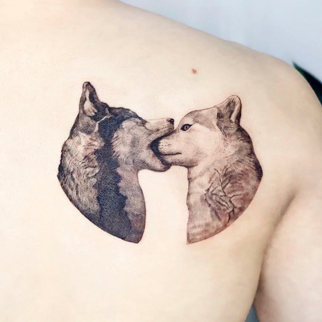 Intricate wolves embracing in stunning tattoo art Tattoo Design