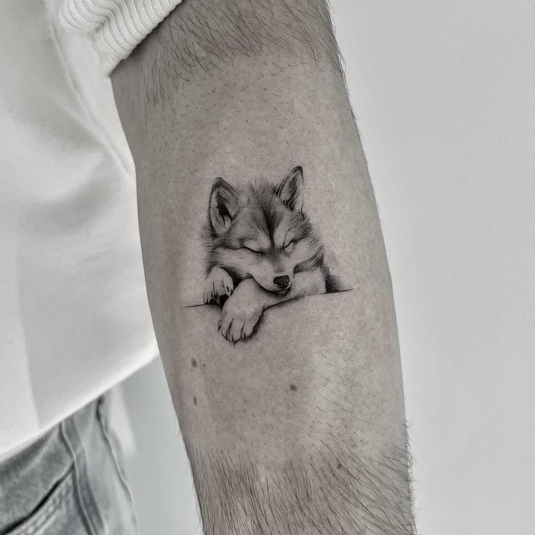 Relaxed wolf tattoo in stunning black ink Tattoo Design