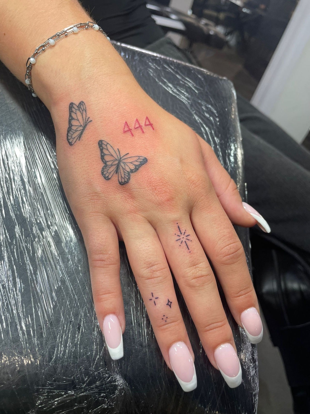 Red 444 hand tattoo with butterflies Tattoo Design