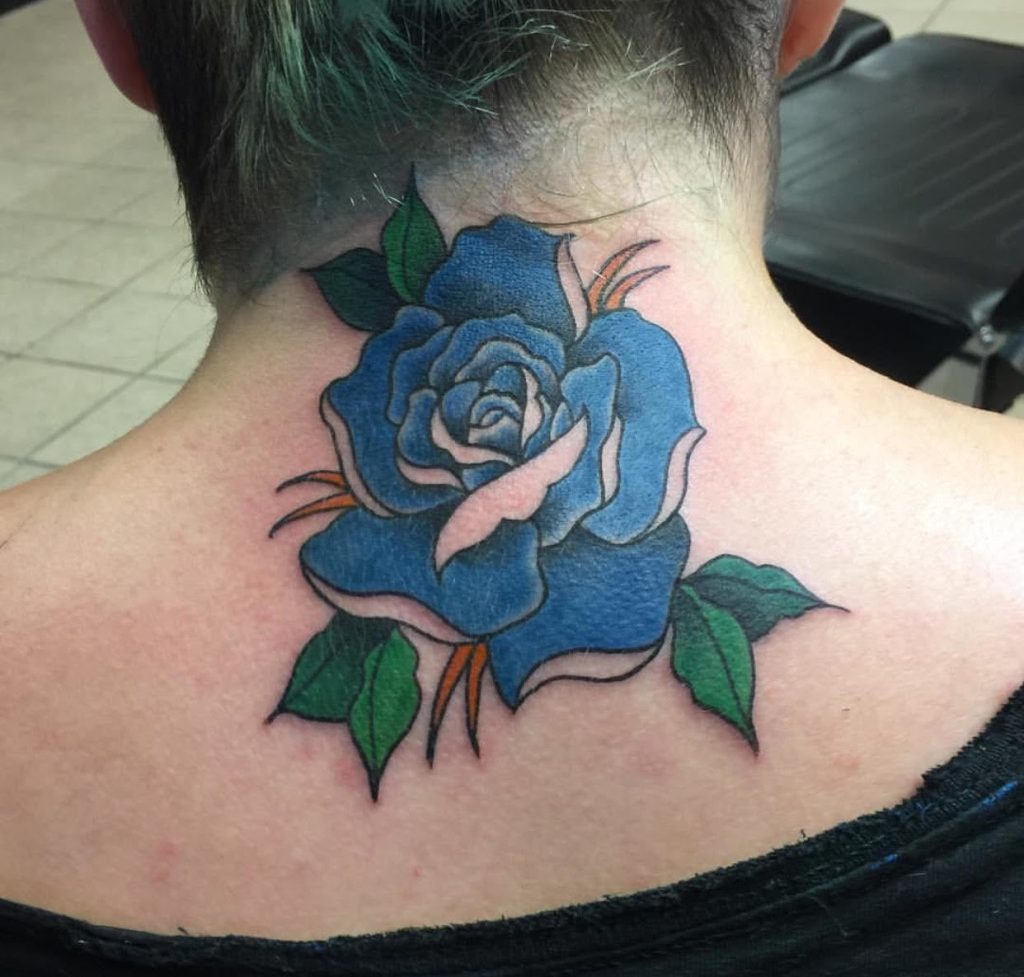 This bold blue rose tattoo adorns the neck, creating a standout look for tattoo enthusiasts.
