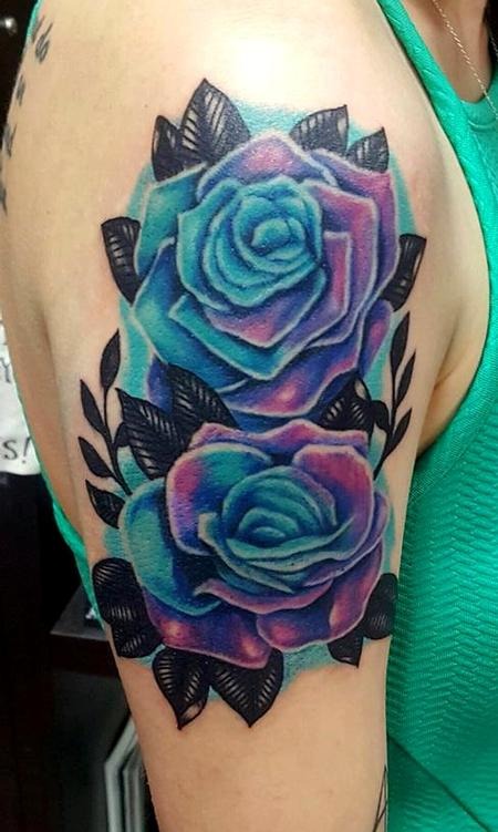 This eye-catching tattoo features two large roses blending hues of blue and purple, creating a mesmerizing gradient effect.